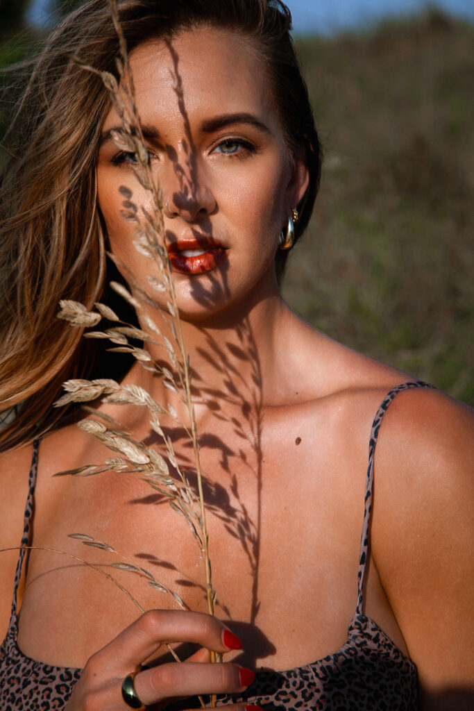 Editorial beach boudoir photography session in Miami during a golden hour sunset.